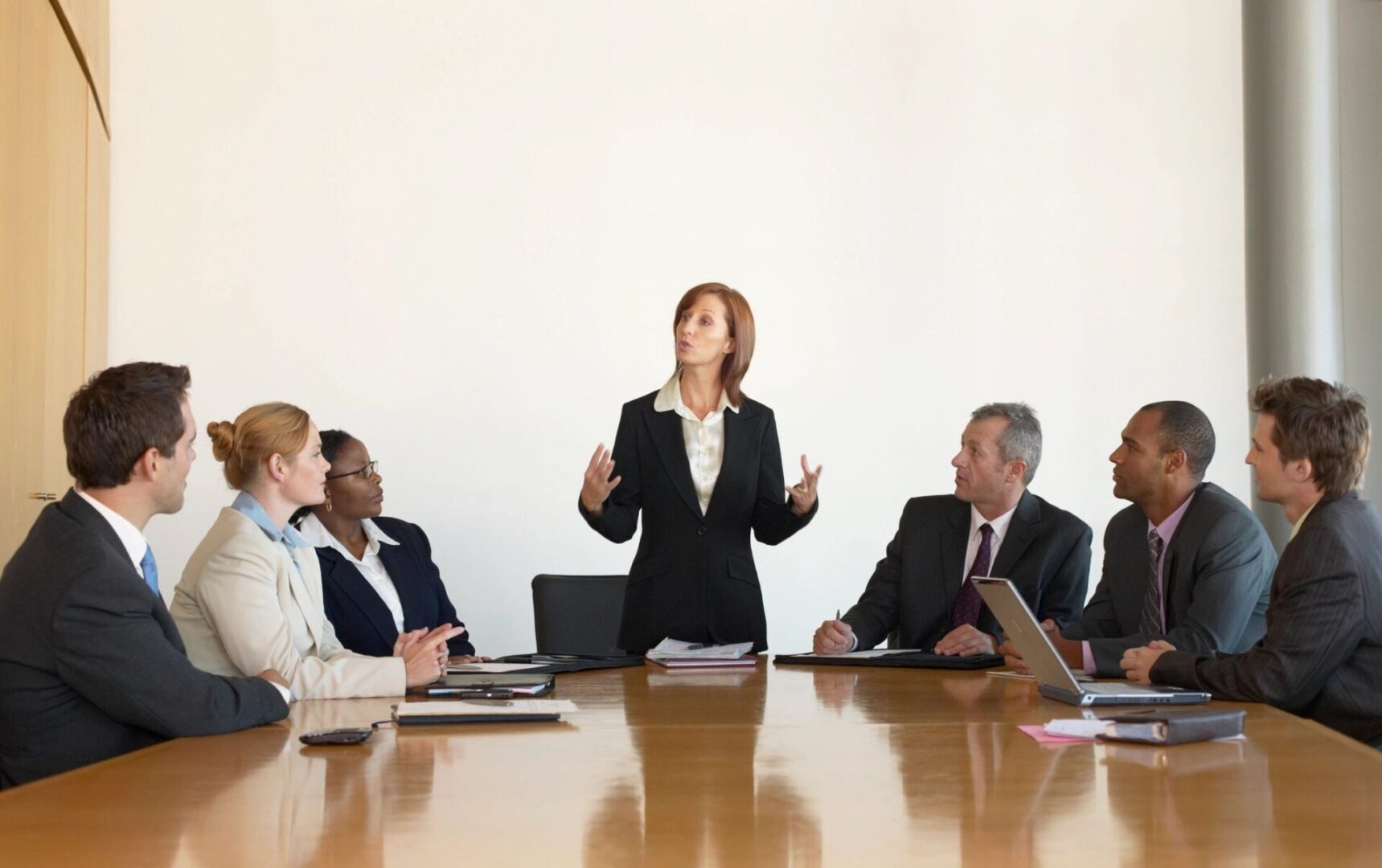 A woman standing at the front of a group of people.